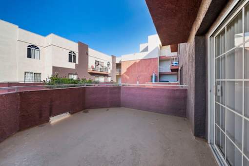 A courtyard surrounded by buildings with a clear blue sky.