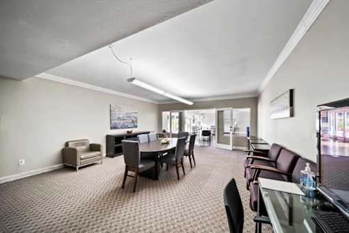 A conference room with a table and chairs.