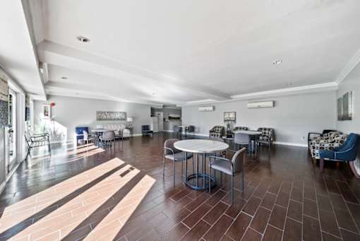 A spacious room with a table and chairs.