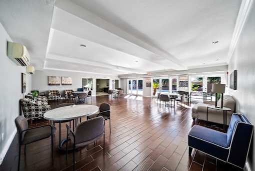 A spacious room with a round table and chairs.