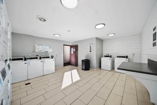 A laundry room with washers and dryers.