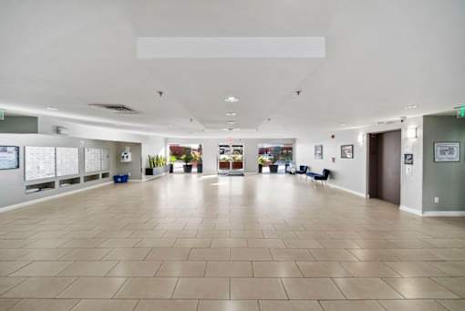 A spacious room with a tiled floor and white walls.