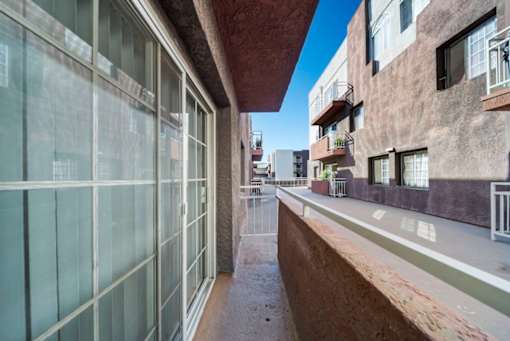 A long, narrow alleyway between two buildings with balconies.