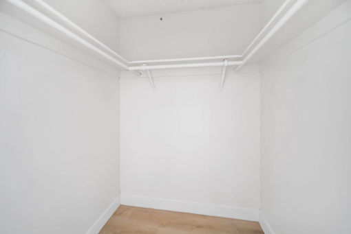 A white room with a wooden floor and white walls.