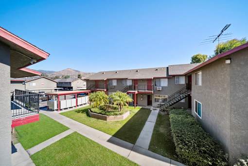 A sunny day at a residential complex with a clear blue sky.