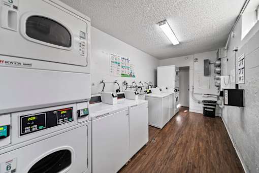 A laundry room with washing machines and a dryer.
