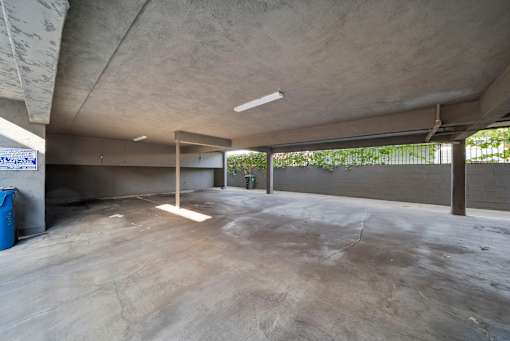 A large, empty, concrete-floored room with a concrete ceiling and walls.