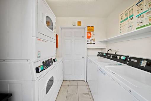 A white laundry room with a washer and dryer.