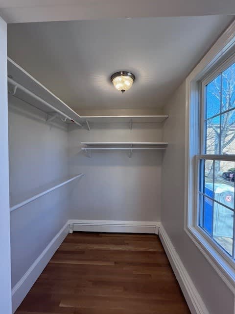 A room with a window and a light on the ceiling.