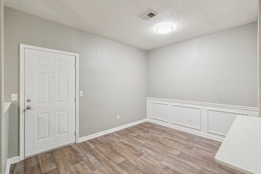 A room with a white door and a wooden floor at The Atlantic Canton Ridge, Georgia