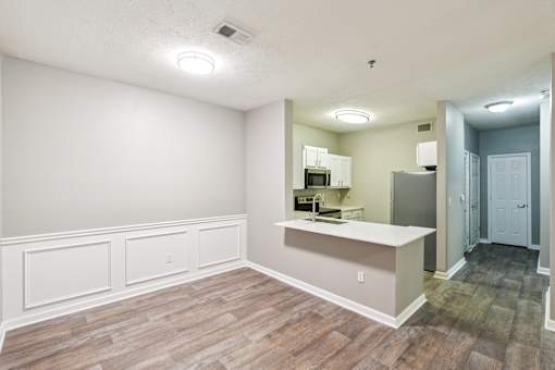 A kitchen area with a counter and cabinets at The Atlantic Canton Ridge, Georgia