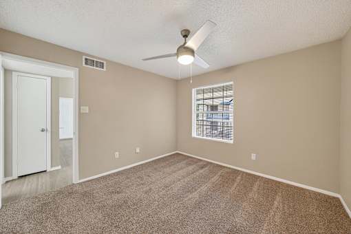 A room with a carpeted floor and a ceiling fan at Logans Mill, Austin, TX.