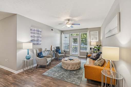 A living room with a sofa, chairs, and a rug at The Atlantic Canton Ridge, Georgia