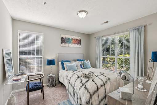 A bedroom with a large bed and a window with blinds at The Atlantic Canton Ridge, Georgia
