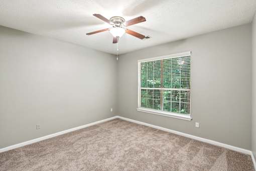 A room with a ceiling fan and a window with blinds at The Atlantic Canton Ridge, Georgia