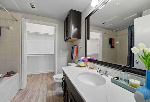 A bathroom with a white sink and a white toilet at The Atlantic Highland Park, Texas, 75209