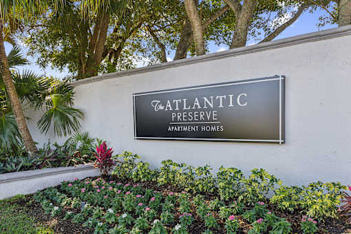 A sign that says Atlantic Reserve in front of some trees.