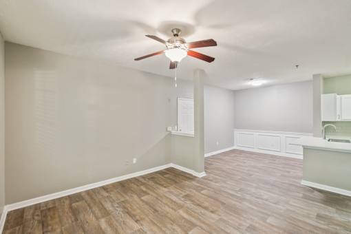 A room with a ceiling fan and wooden flooring at The Atlantic Canton Ridge, Georgia