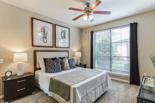 Bedroom with ceiling fan and large window at Vintage Park Apartments, Houston, TX