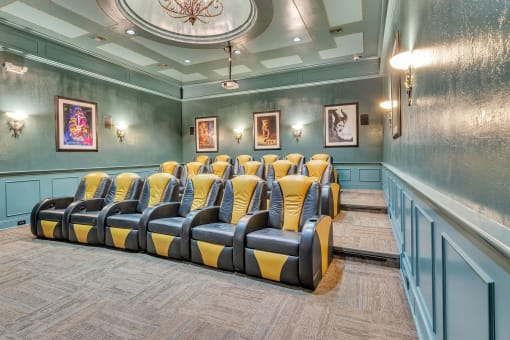 Theater room with blue and yellow chairs and a chandelier at Vintage Park Apartments, Texas