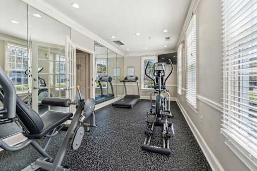 A spacious home gym with a variety of exercise equipment.