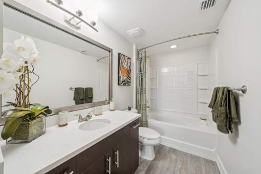 A bathroom with a white counter top and a white toilet at The Atlantic at Tradition, Port St Lucie