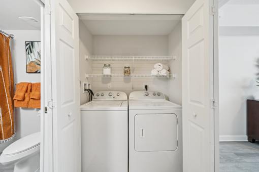 A small laundry room with a towel hanging on the wall at The Atlantic at Tradition, Port St Lucie