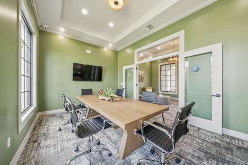 A conference room with a long table and chairs at The Atlantic at Tradition, Port St Lucie