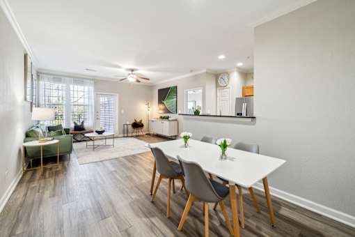 A dining room with a white table and chairs at The Atlantic Stone Oak Apartments, San Antonio