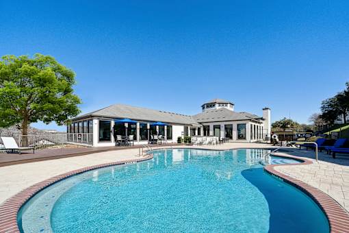A large swimming pool in front of a house at The Atlantic Stone Oak Apartments, San Antonio, TX.