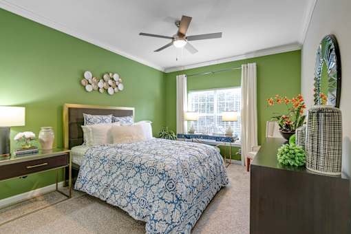 A bedroom with a bed, a ceiling fan, and a mirror at The Atlantic Buckhead Apartments, Atlanta, GA, 30305