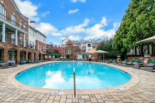 A large swimming pool surrounded by lounge chairs and buildings at The Atlantic Buckhead Apartments, Georgia 30305