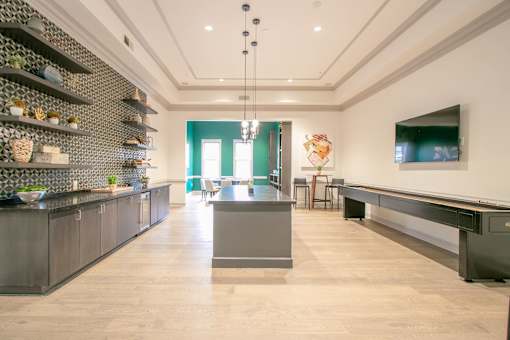 A modern kitchen with a long island in the middle at The Atlantic Buckhead Apartments, Atlanta, Georgia