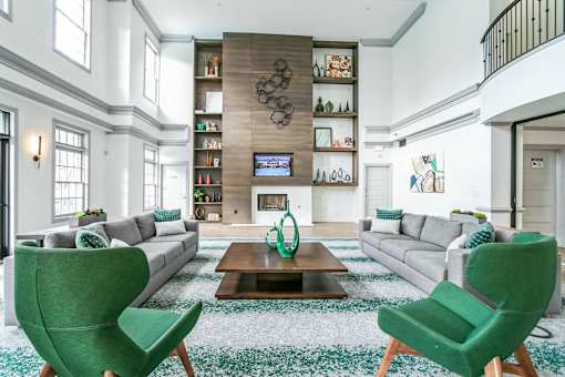 A living room with a fireplace and a TV on the wall at The Atlantic Buckhead Apartments, Atlanta