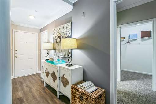 A white cabinet with a lamp on top is in a room at The Atlantic Buckhead Apartments, Georgia 30305