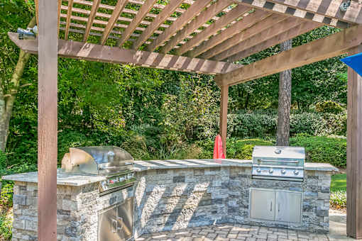 Outdoor kitchen with a grill at The Atlantic Ashford, Atlanta, Georgia