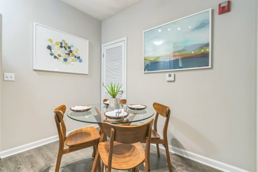 Dining room with a glass table and chairs at The Atlantic North Highland, Charlotte