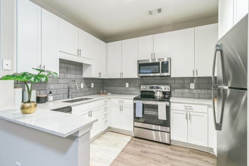Kitchen with white cabinets at The Atlantic North Highland, Charlotte