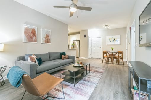 A living room with a grey couch at The Atlantic North Highland, Charlotte