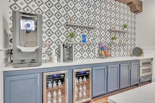Kitchen bar with blue cabinets and a coffee machine at The Atlantic Mira Loma, Live Oak, 78233
