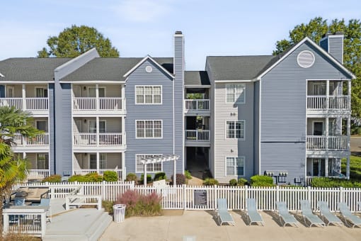 an image of an apartment building with chairs in front of it at Magnolia Terrace Apartments, Charlotte, NC, 28213