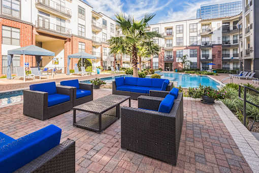 A patio with a pool and chairs  at The Atlantic Memorial, Houston