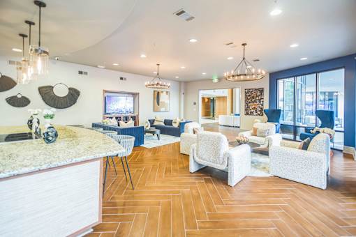 Resident lounge with a curved ceiling, hardwood floors, and a kitchen island  at The Atlantic Memorial, Houston