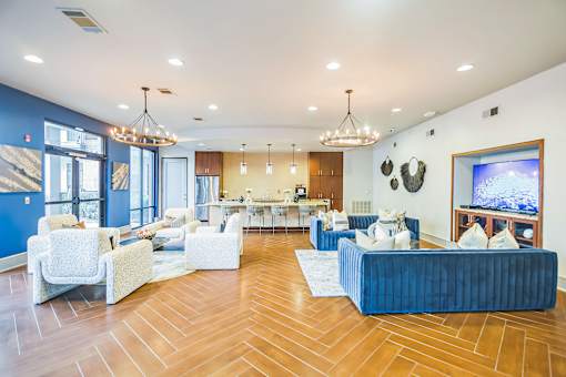 A living room with white furniture and a blue couch  at The Atlantic Memorial, Houston