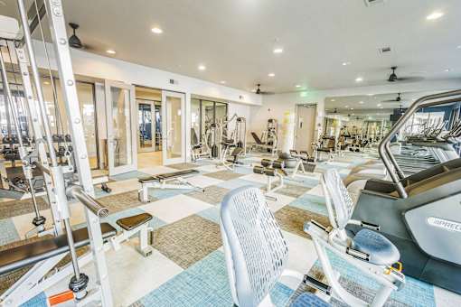 a gym with treadmills and other exercise equipment at the renaissance valencia resort