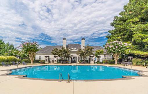 A large swimming pool in front of a house with a pool house.at The Atlantic Canton Ridge, Canton, GA 30114  