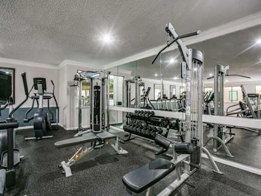 A well-equipped gym with a variety of machines and weights. at Montecito Apartments, Texas, 77056