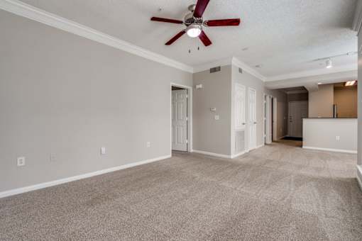 A spacious room with a ceiling fan and carpeted floor. at Montecito Apartments, Houston, Texas