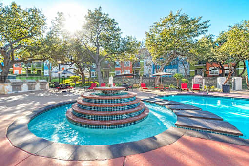 A pool with a fountain in the middle of it at Reserve at Canyon Creek,Texas