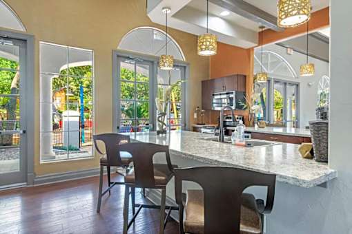 A kitchen with a counter and chairs. at Reserve at Canyon Creek, San Antonio, Texas